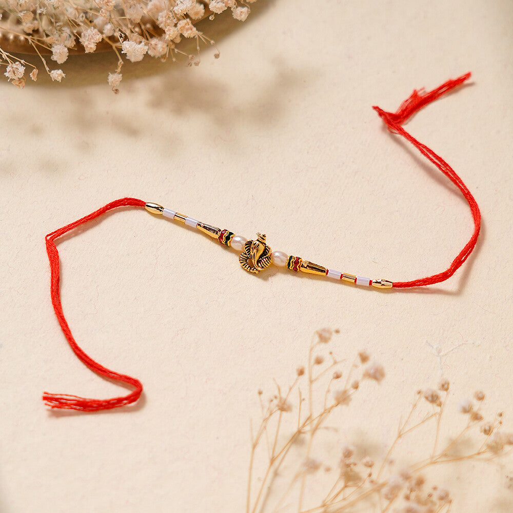 Madhoor Ganesha Pearl Rakhi Red 1 Piece