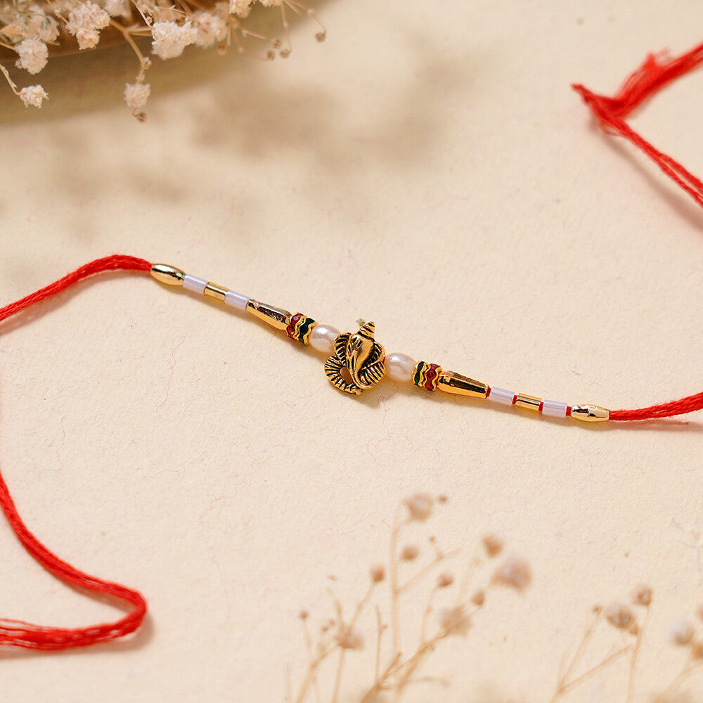 Madhoor Ganesha Pearl Rakhi Red 1 Piece
