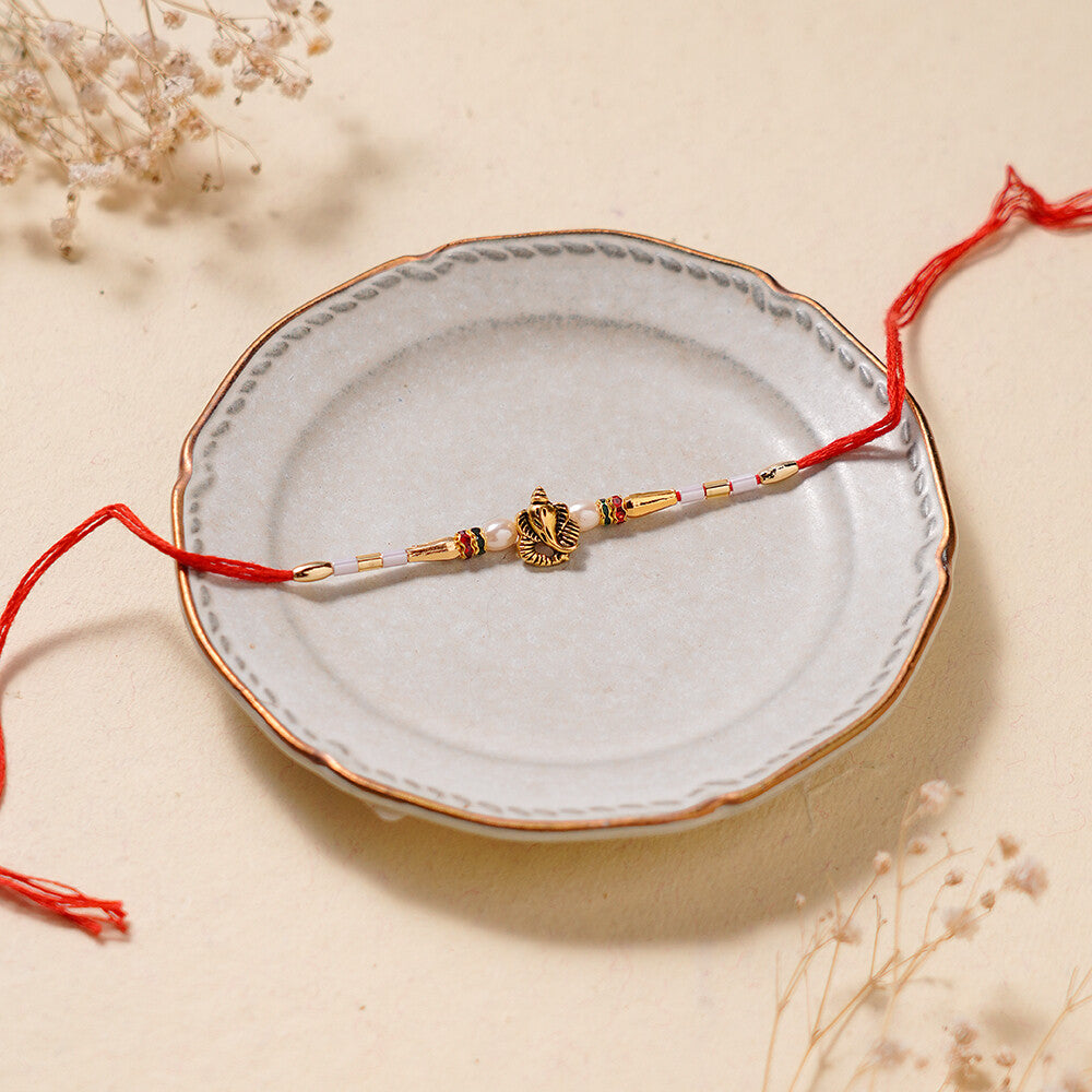 Madhoor Ganesha Pearl Rakhi Red 1 Piece