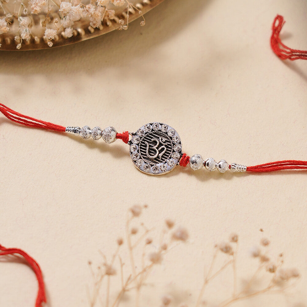 Madhoor Om Rakhi Red Silver-Tone 1 Piece